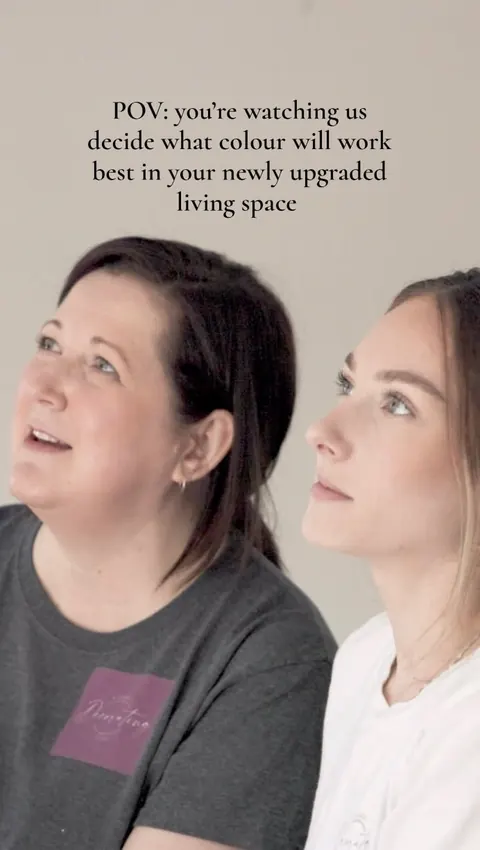 Melissa and Taylor studying a wall during a colour consultation